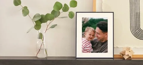 Aura Aspen 12-inch digital frame standing vertically on a shelf