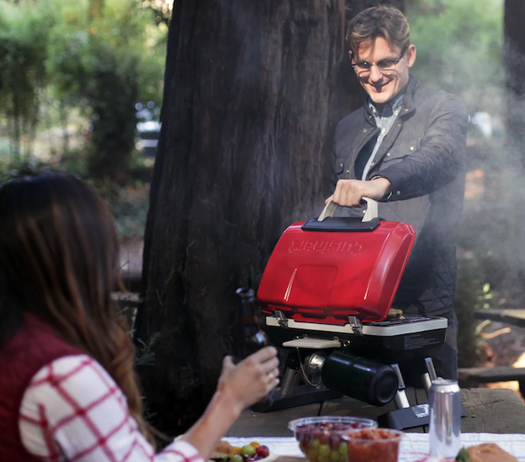Cuisinart Petite Gourmet CGG-180T red tabletop grill in an outdoor picnic setting