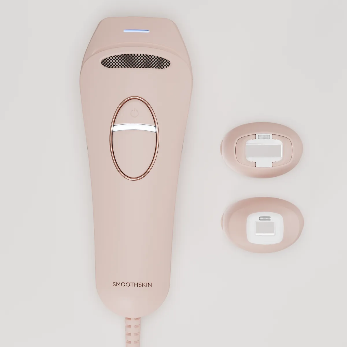 SmoothSkin Pure Switch handset beside two detachable heads