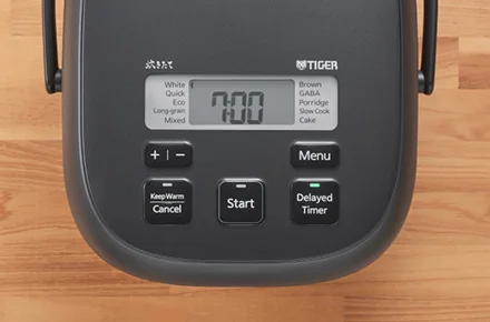 Tiger JBS-A55U control panel showing White, Brown, Long-grain and other menu labels